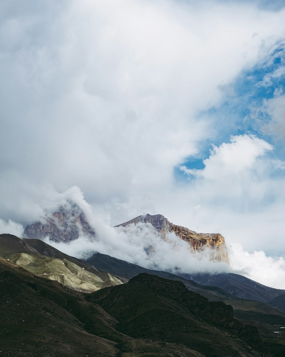 a mountain with clouds