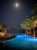 Seaside Pool Villa basking in soft moonlight with gentle waves in the background.