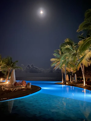 Seaside Pool Villa basking in soft moonlight with gentle waves in the background.