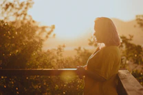 a person leaning on a railing
