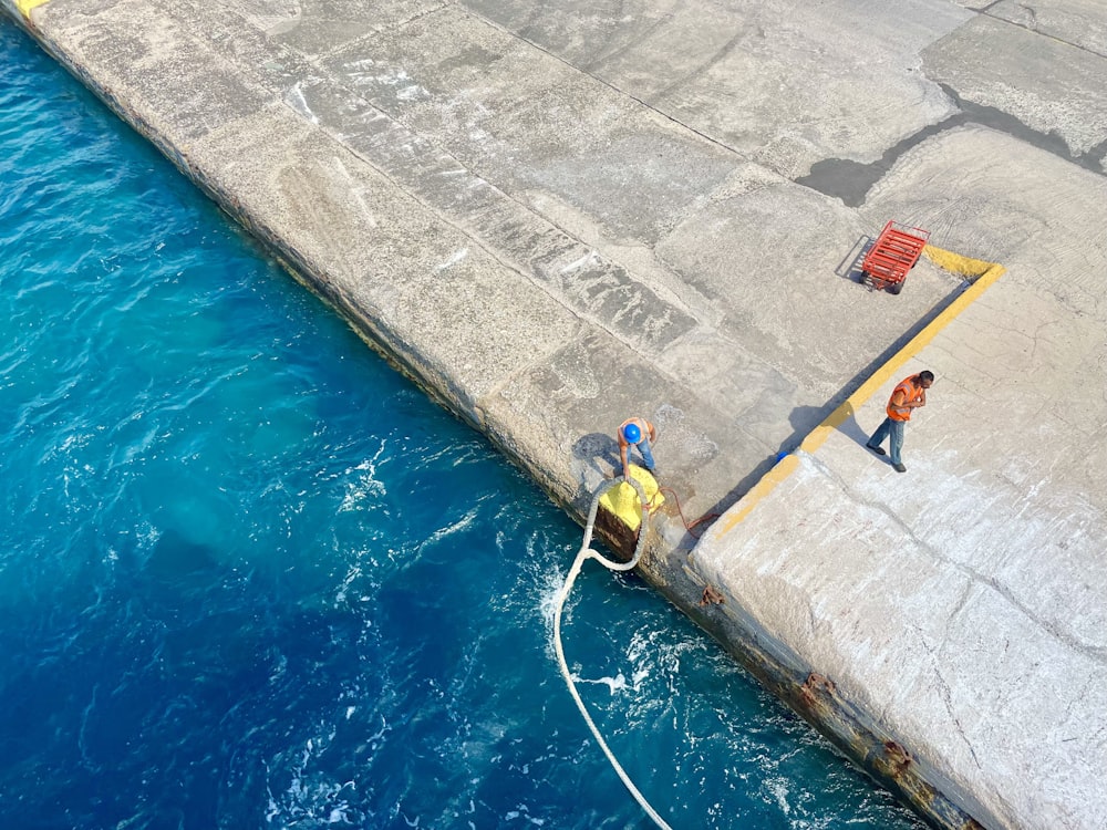 a few men working on a dam