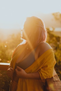 A vibrant top paired with neutral-toned pants, styled on a sunlit balcony.