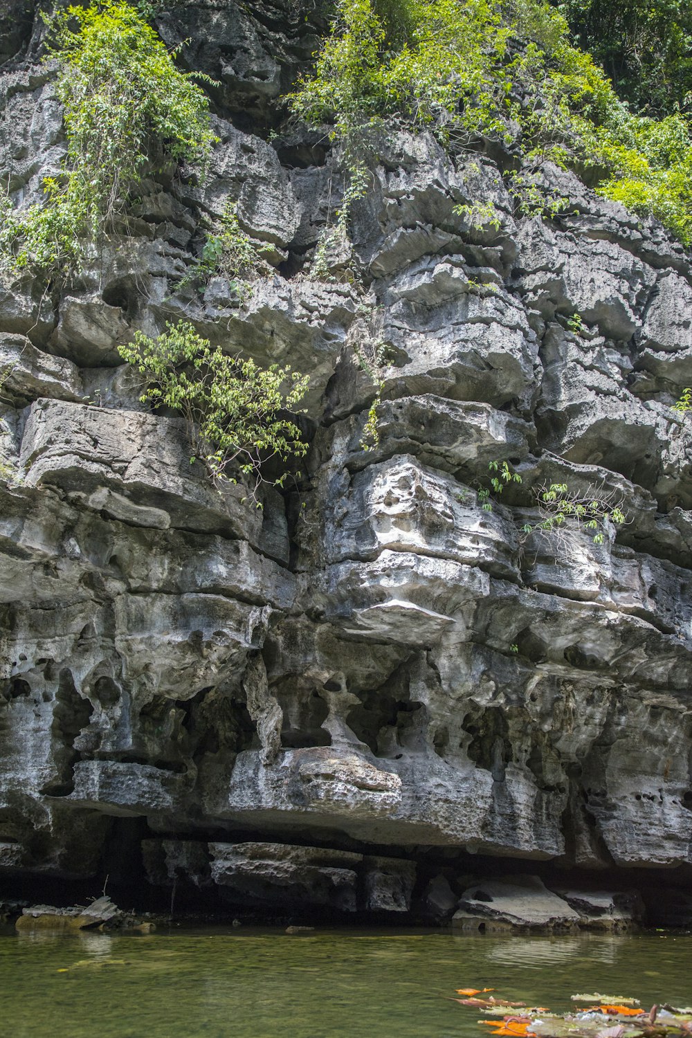 a cliff side with a body of water below