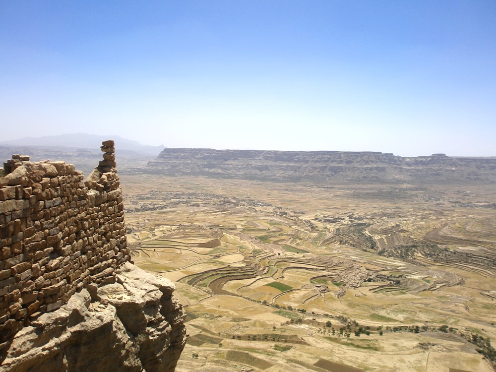 a large canyon with a few buildings