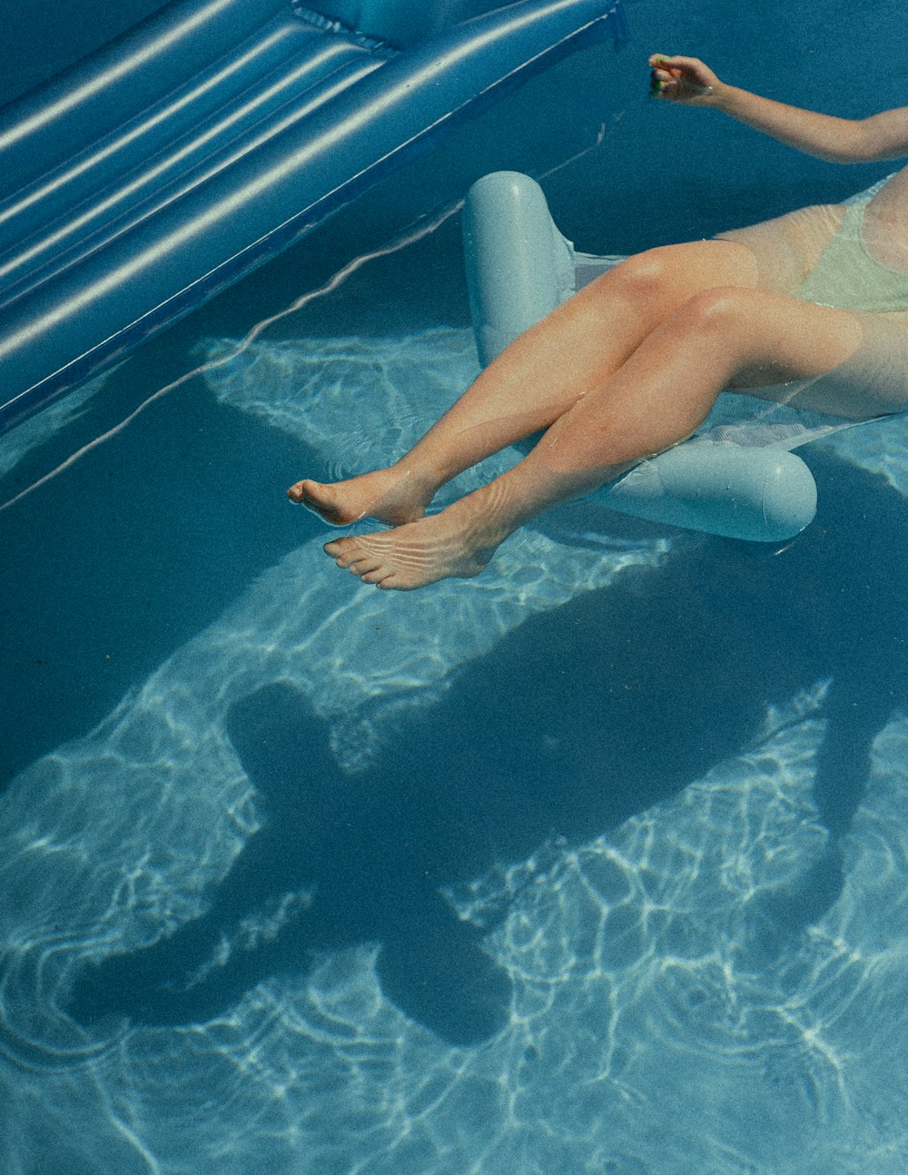 a person lying on a chair in a pool
