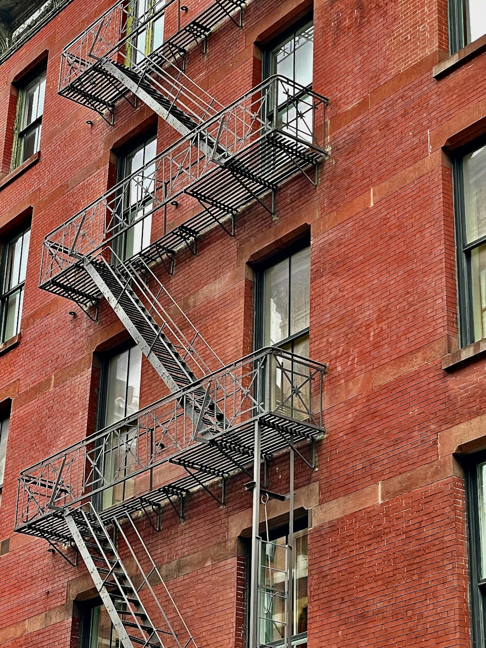 a brick building with multiple balconies and windows