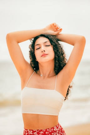 a woman standing next to a body of water