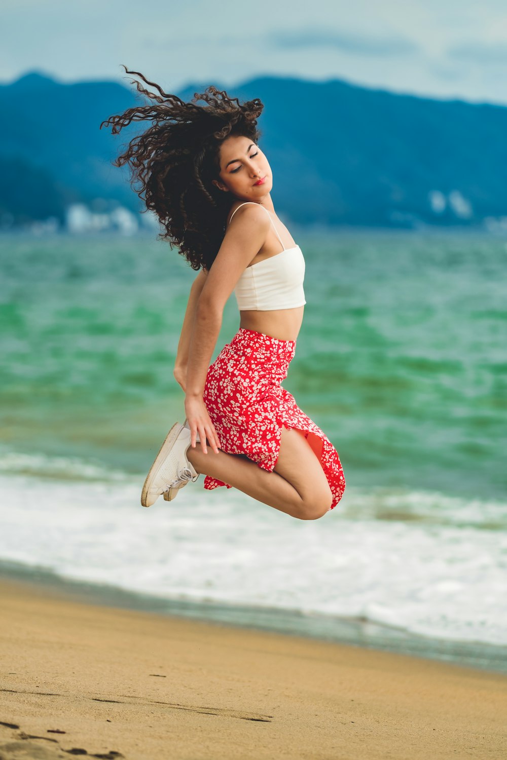a woman posing on a beach