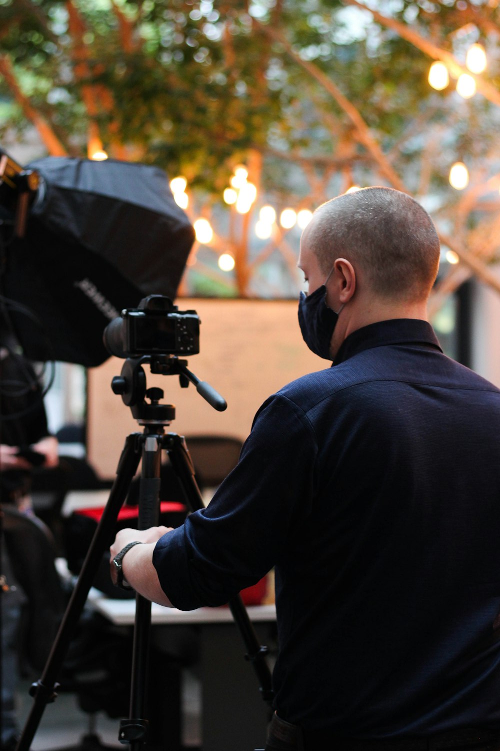 a man looking through a camera