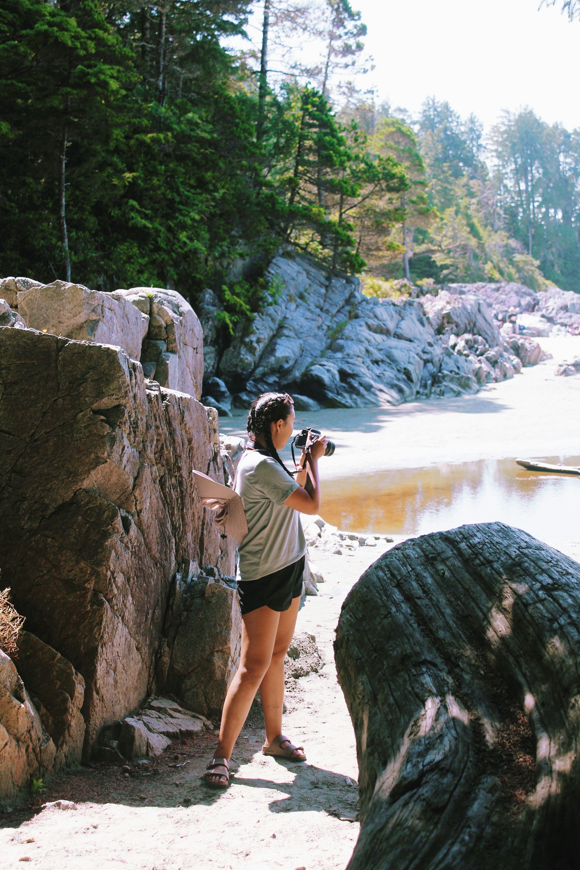 a man taking a picture of a waterfall