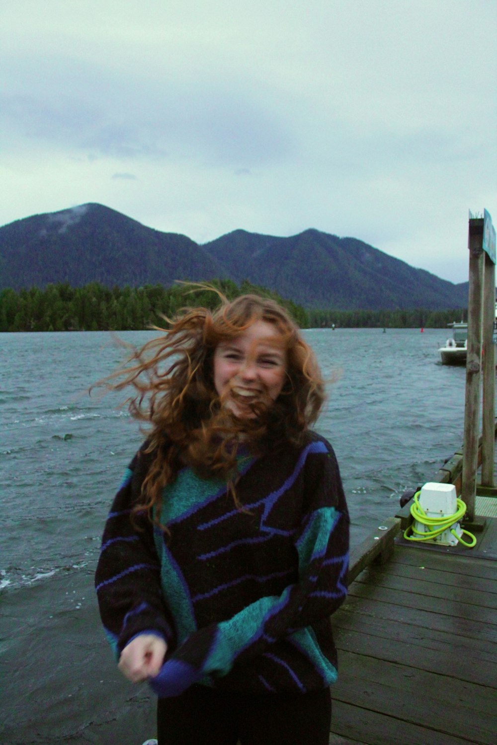 a woman standing on a dock