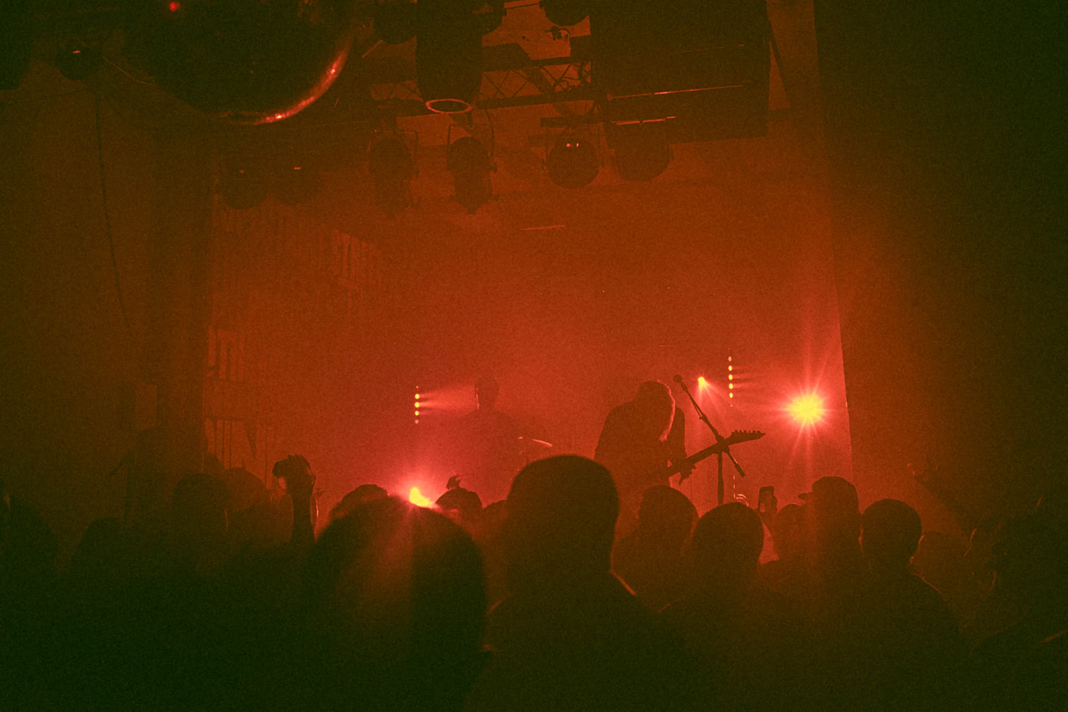 Live performance under dramatic red stage lighting