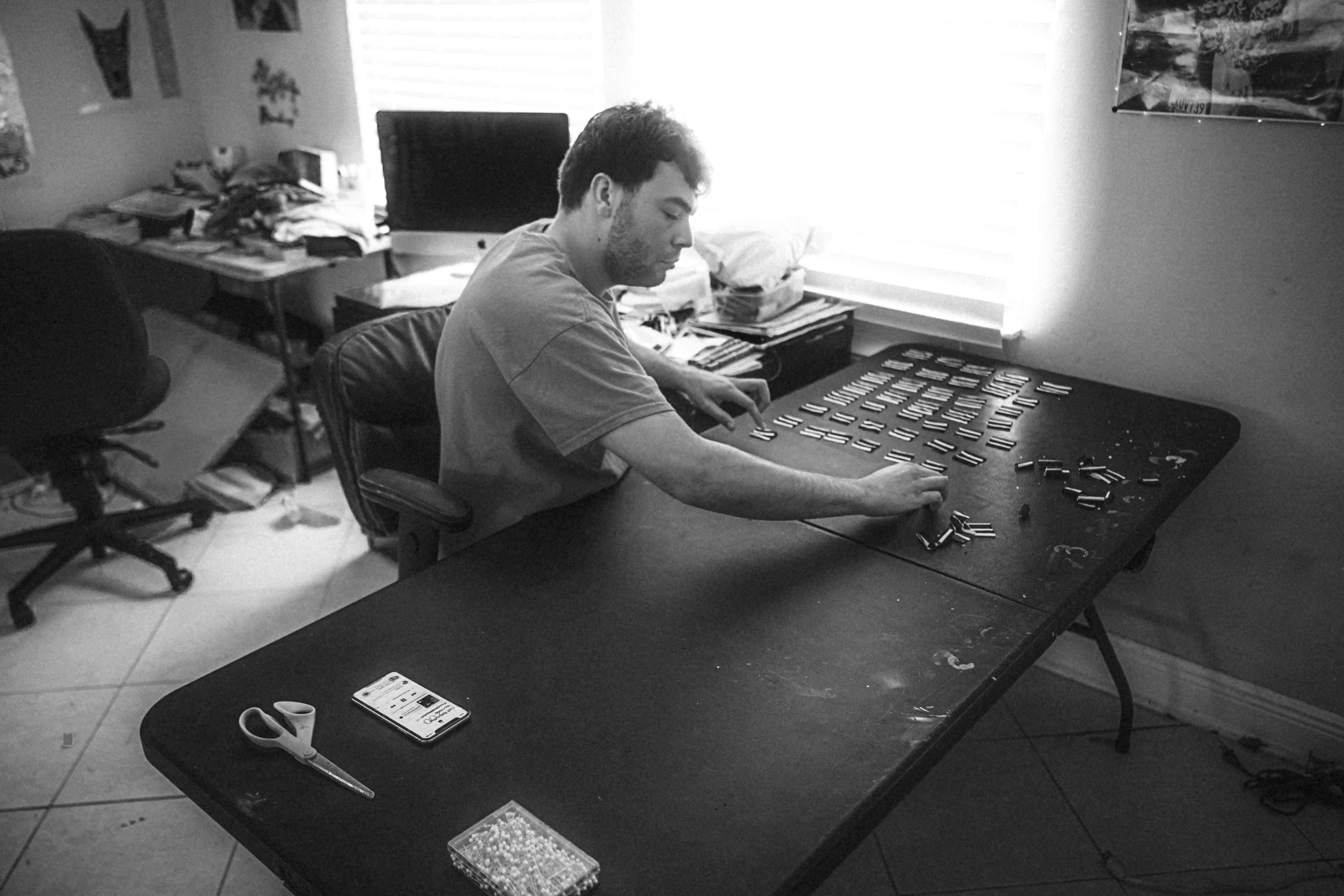 a man sitting at a desk playing a keyboard