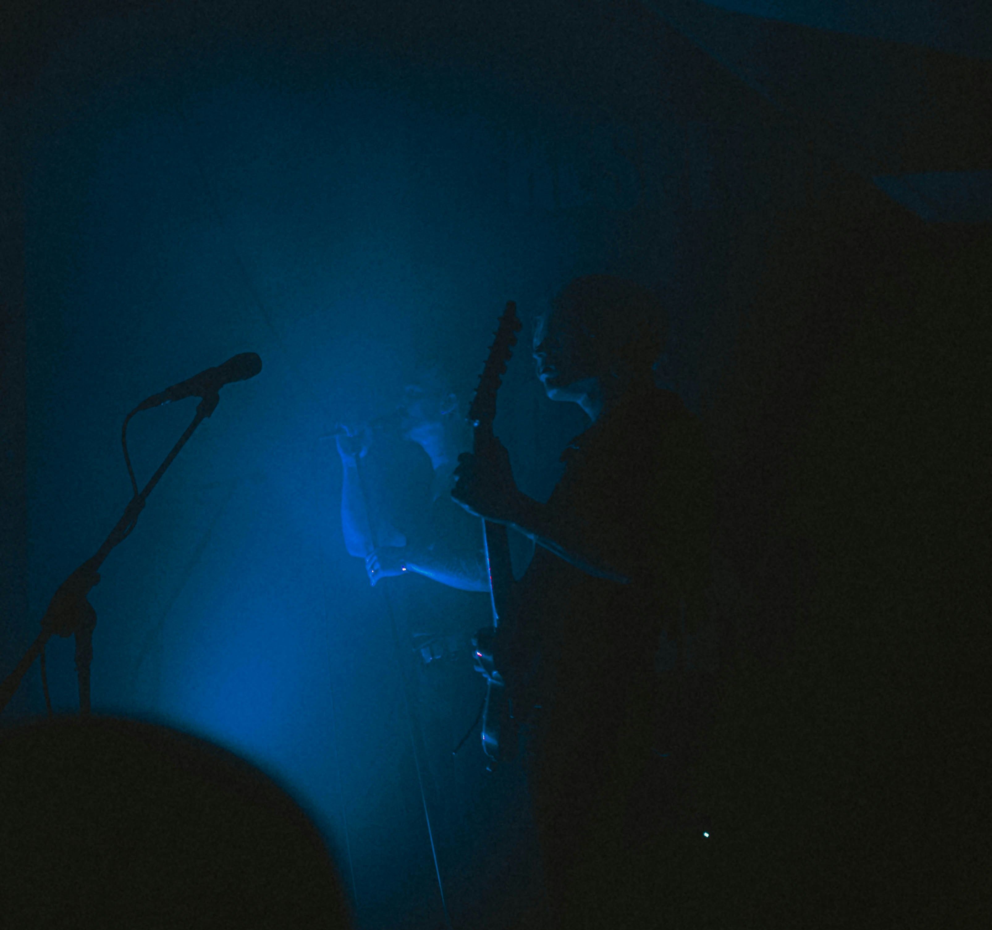 a person playing a guitar on stage