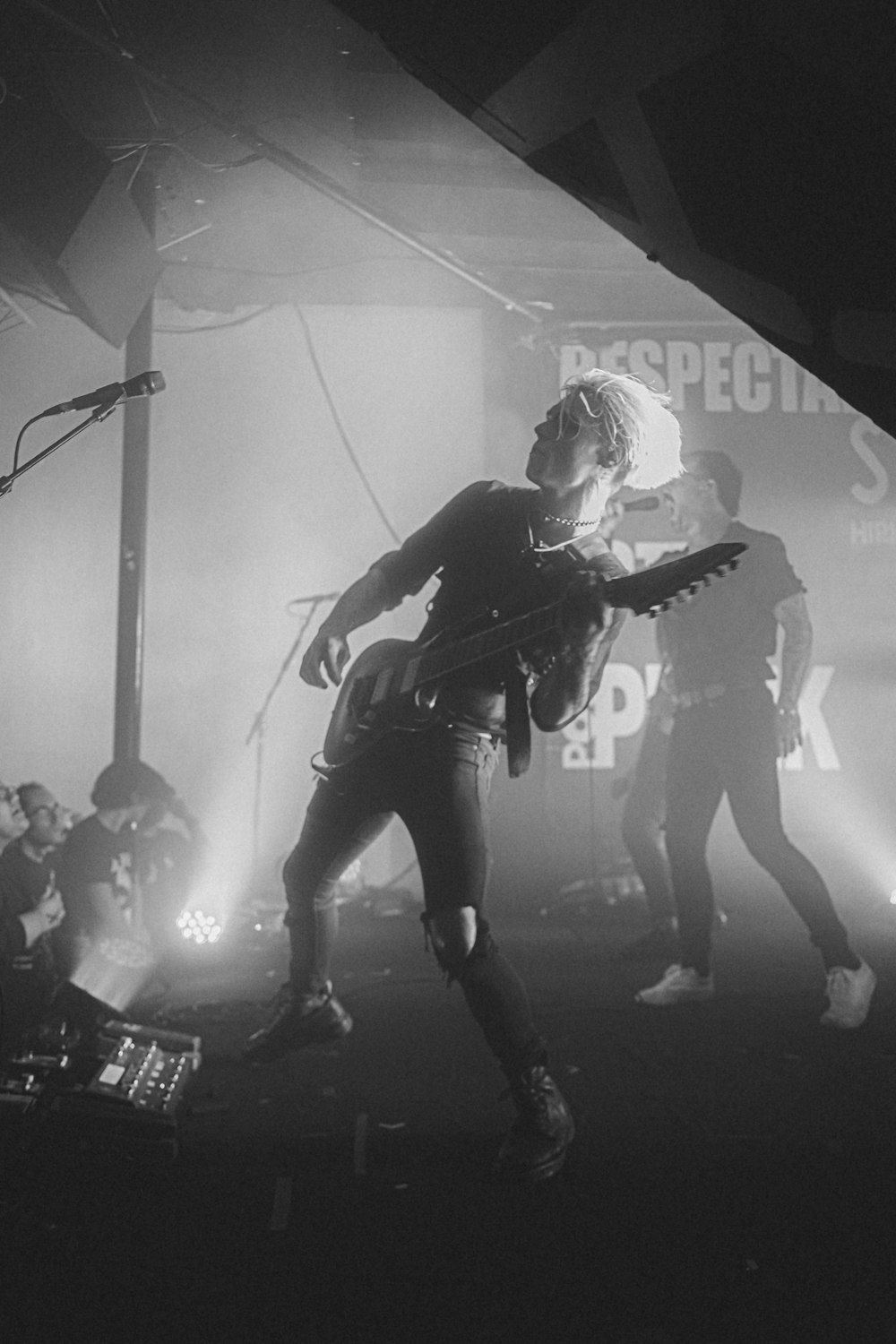 a man holding a guitar on a stage