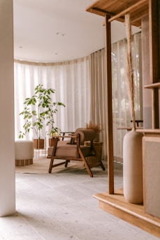 Interior of a calm, minimalist living room with natural light and plants