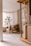 A calm, organized living room bathed in natural light with minimalist decor.