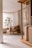A calm, organized living room bathed in natural light with minimalist decor.