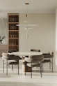 Contemporary dining area featuring a minimalist table and elegant chairs in a neutral palette.