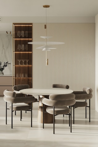 Contemporary dining area featuring a minimalist table and elegant chairs in a neutral palette.