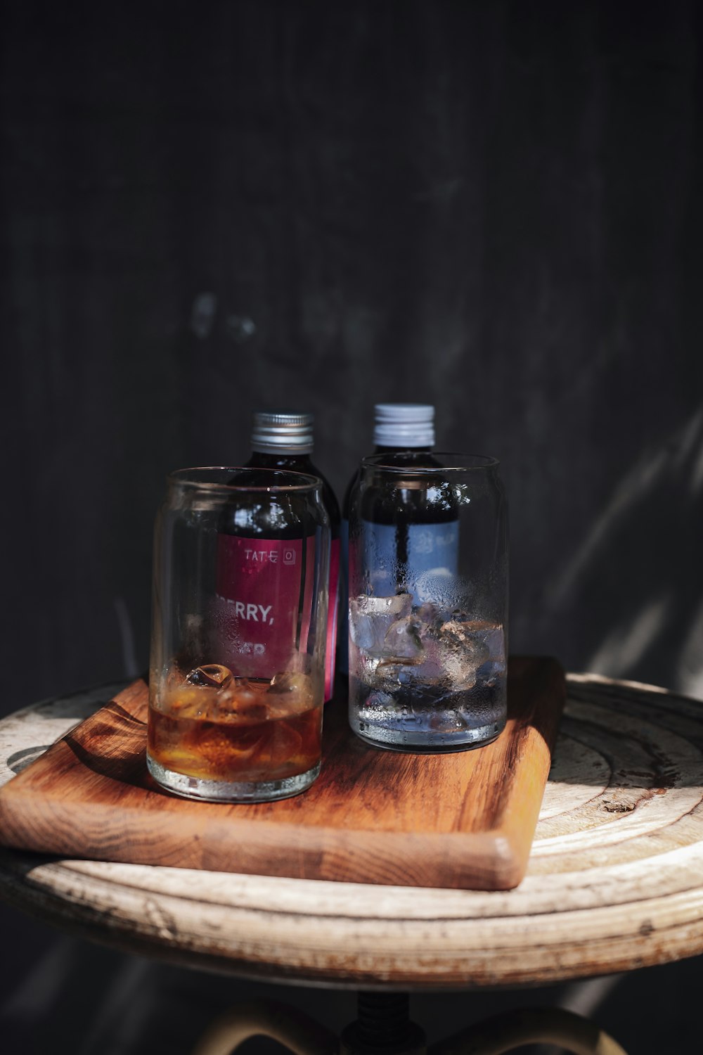 a couple of glass bottles on a wooden surface