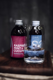 a glass bottle with a liquid in it next to a glass bottle