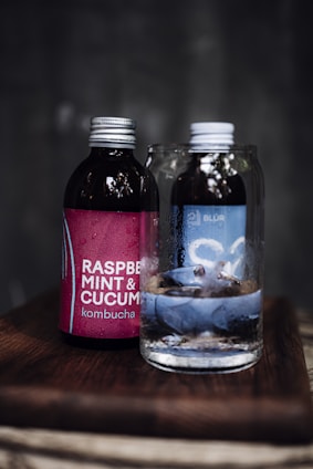 a glass bottle with a liquid in it next to a glass bottle