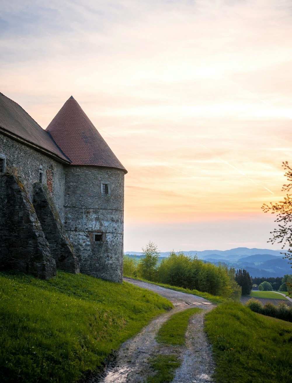 a stone building with a stream running through it