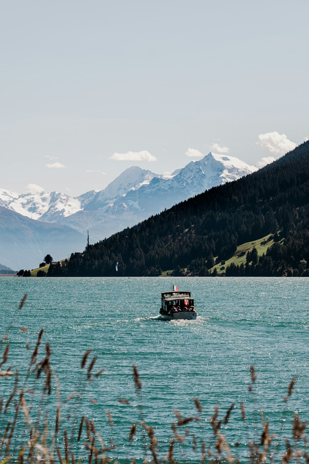 a boat in the water with mountains in the background