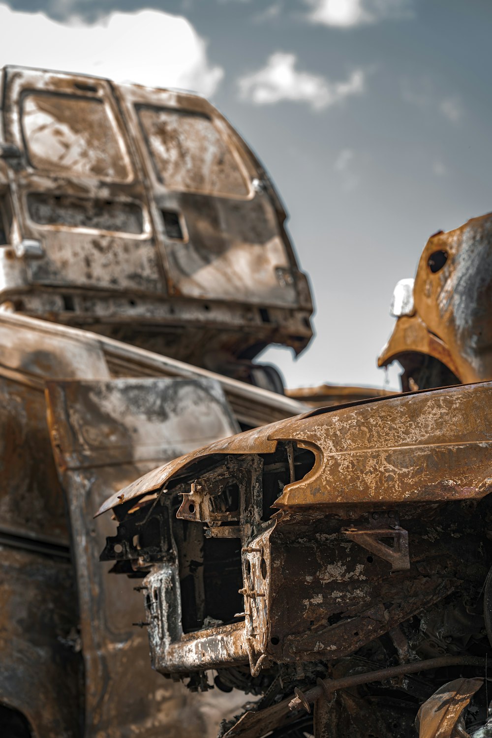 a rusted out car with a dent in the front