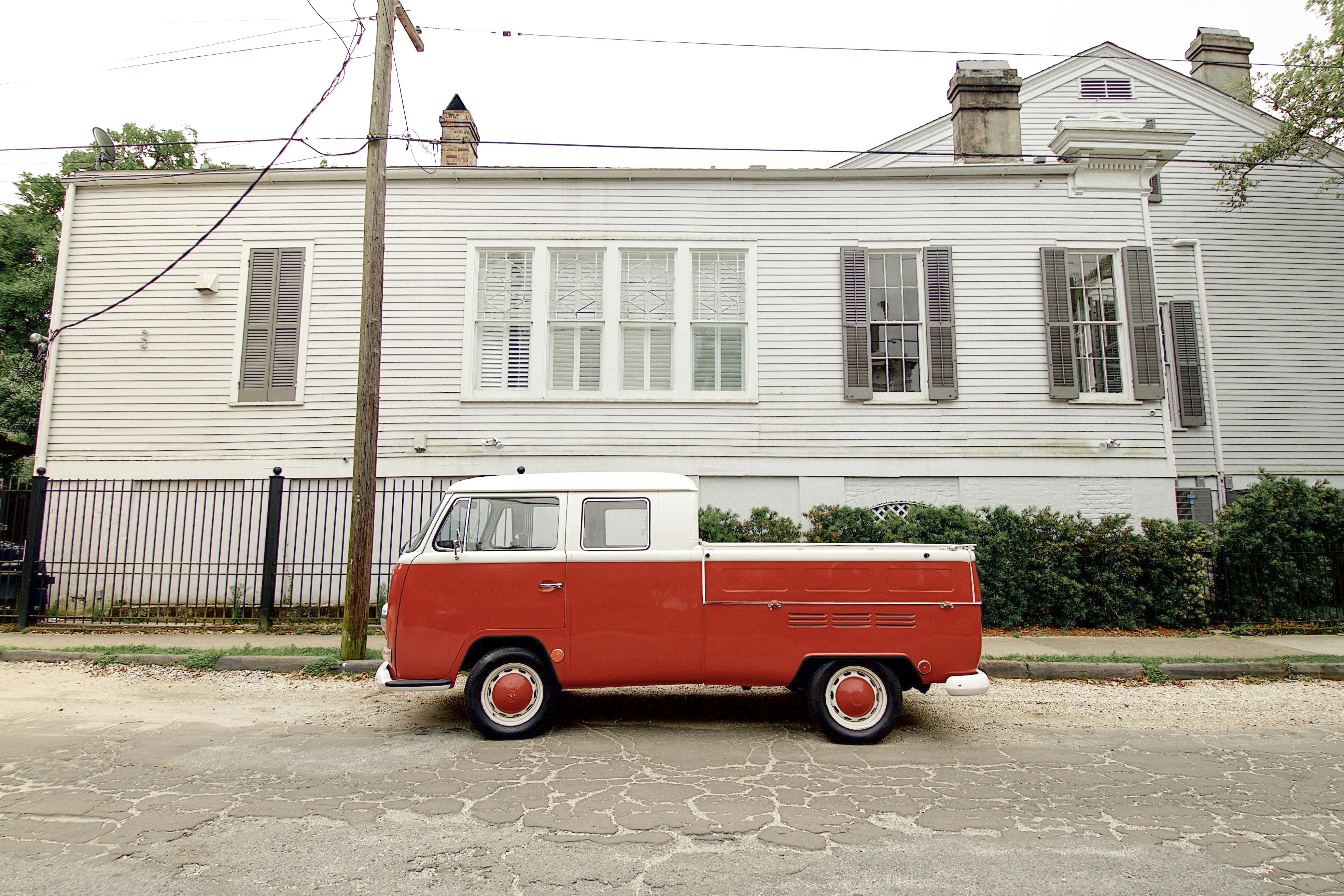 Red VW bus parked on the side of the street in New Orleans, LA.