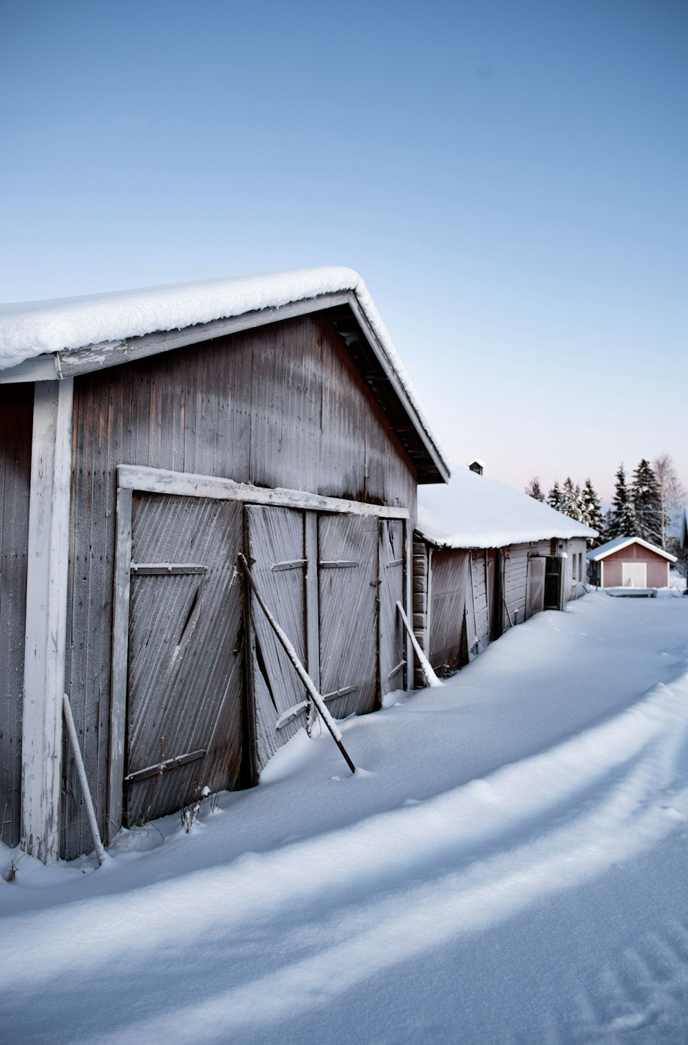 a row of sheds in the snow