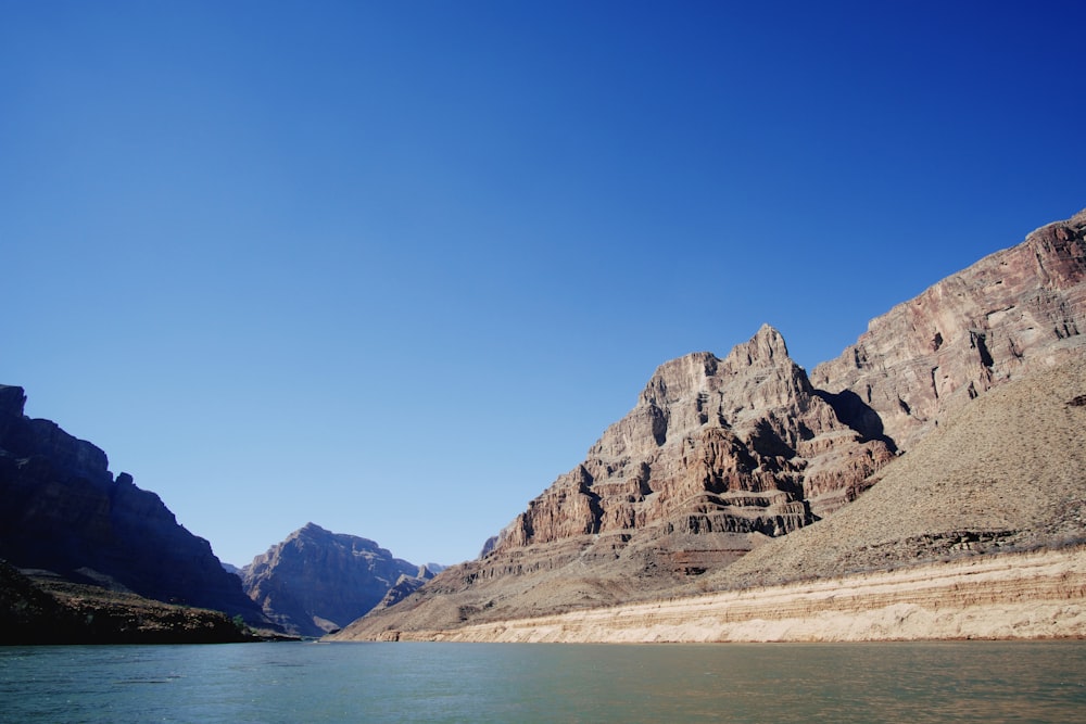 a body of water with mountains in the background