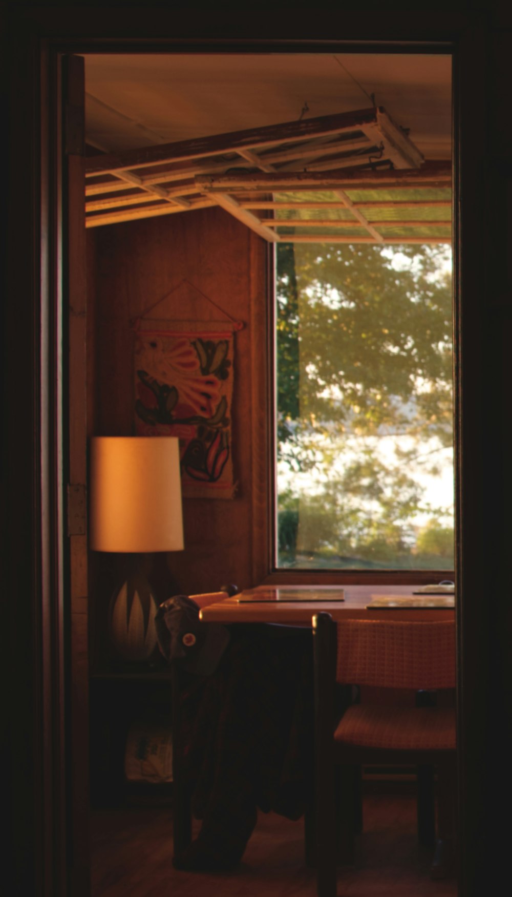 a lamp and a table in a room with a window