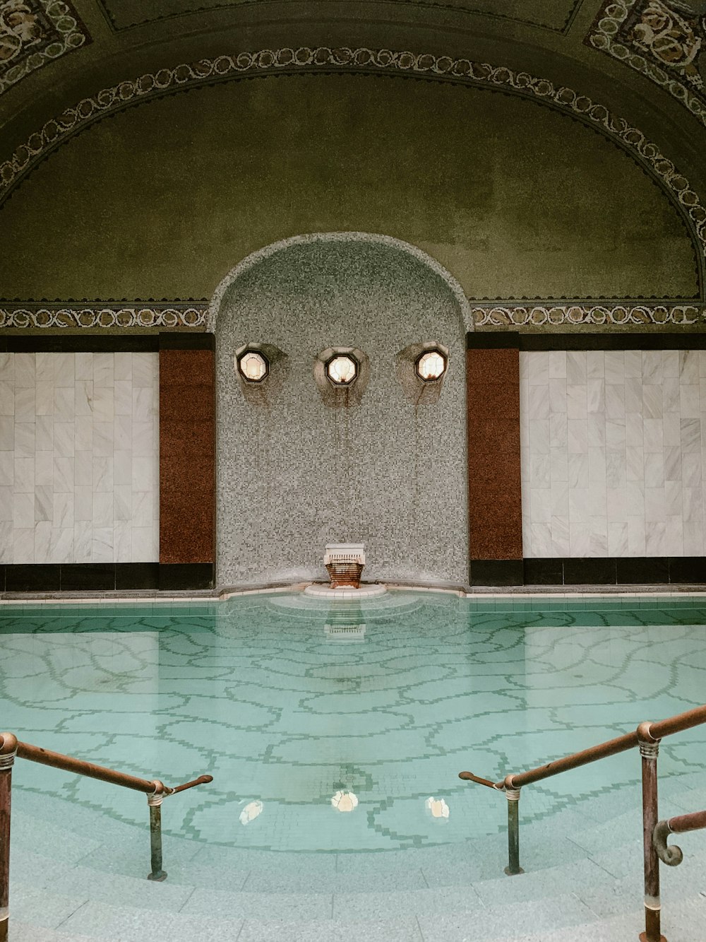 a pool with a stone wall