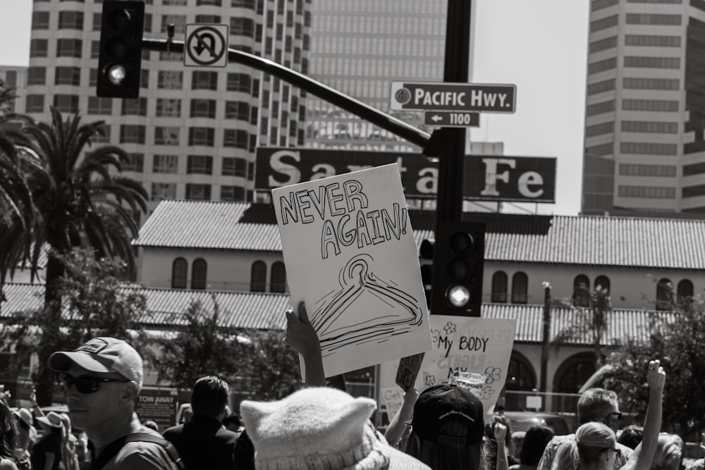 a crowd of people holding signs