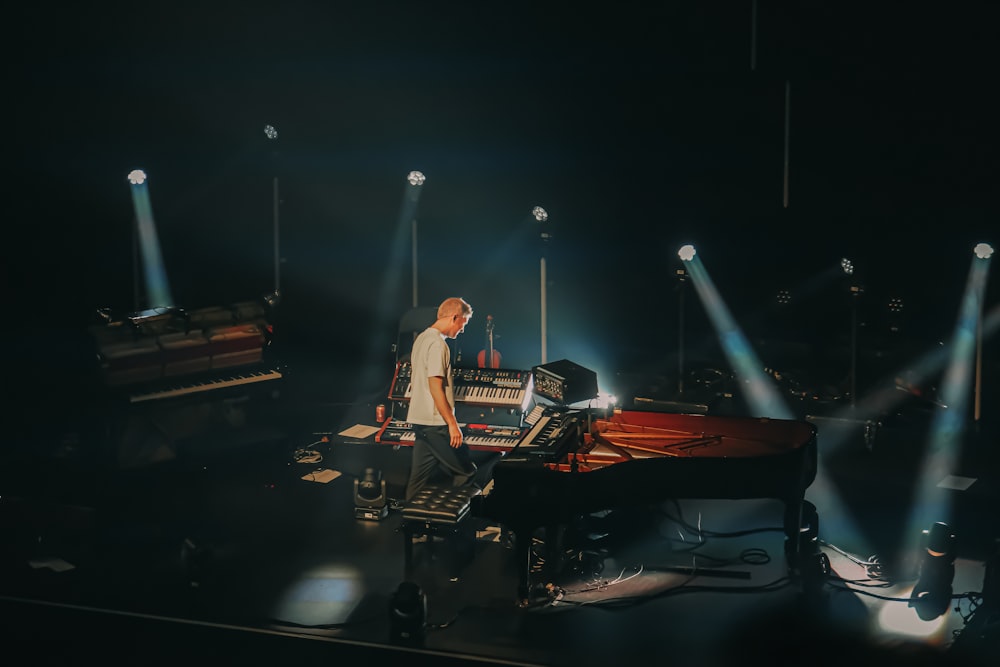 a person on a stage with a keyboard and microphone