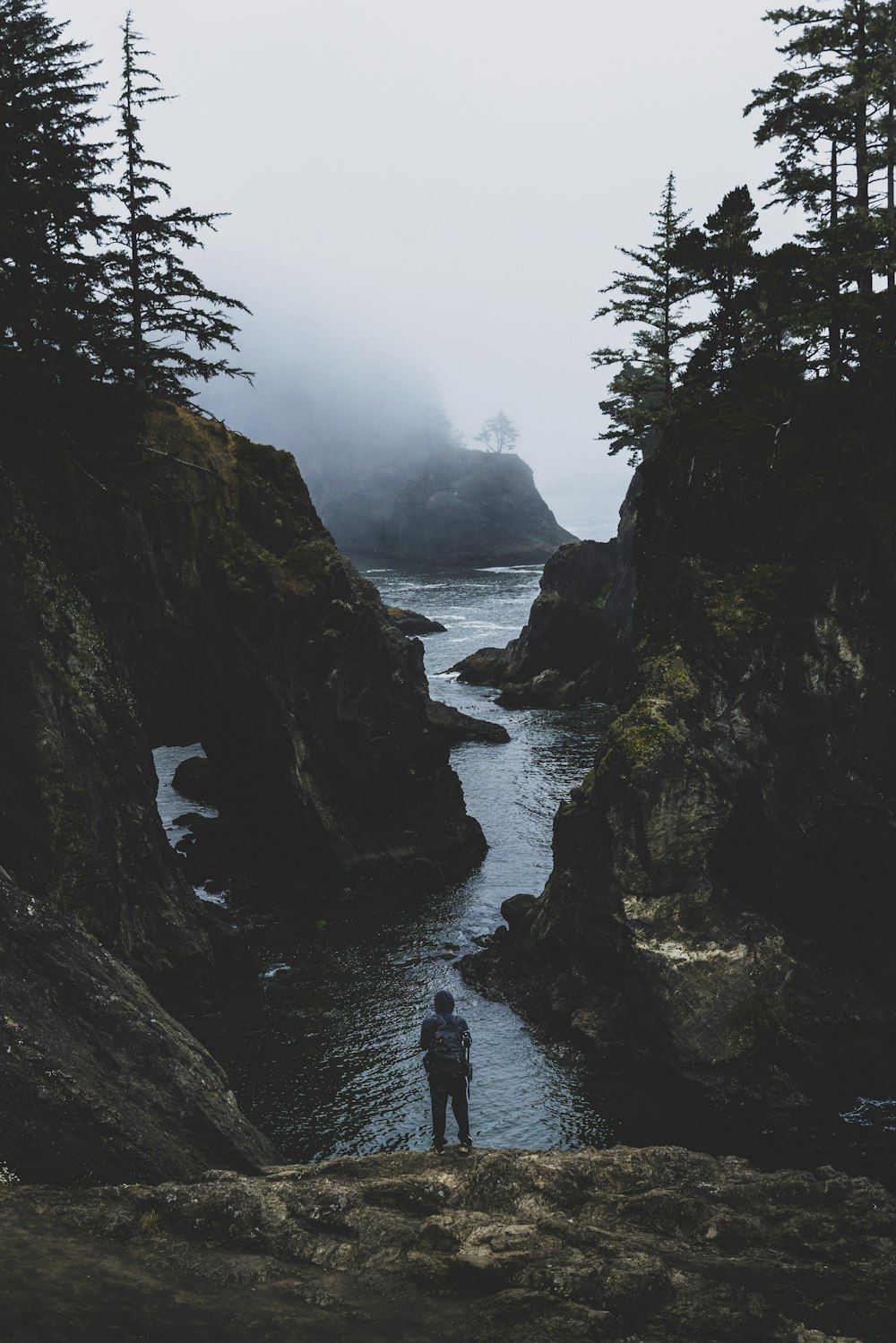 a person standing on a rocky cliff