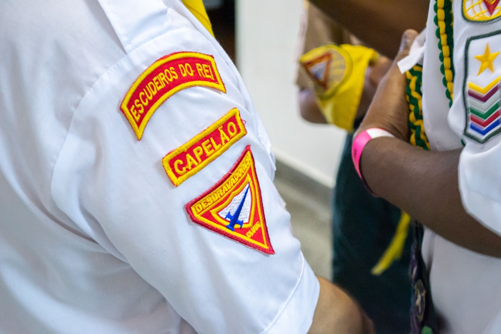 a person holding a yellow and white shirt