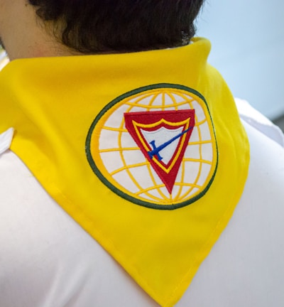 a man wearing a yellow shirt with a blue and yellow logo