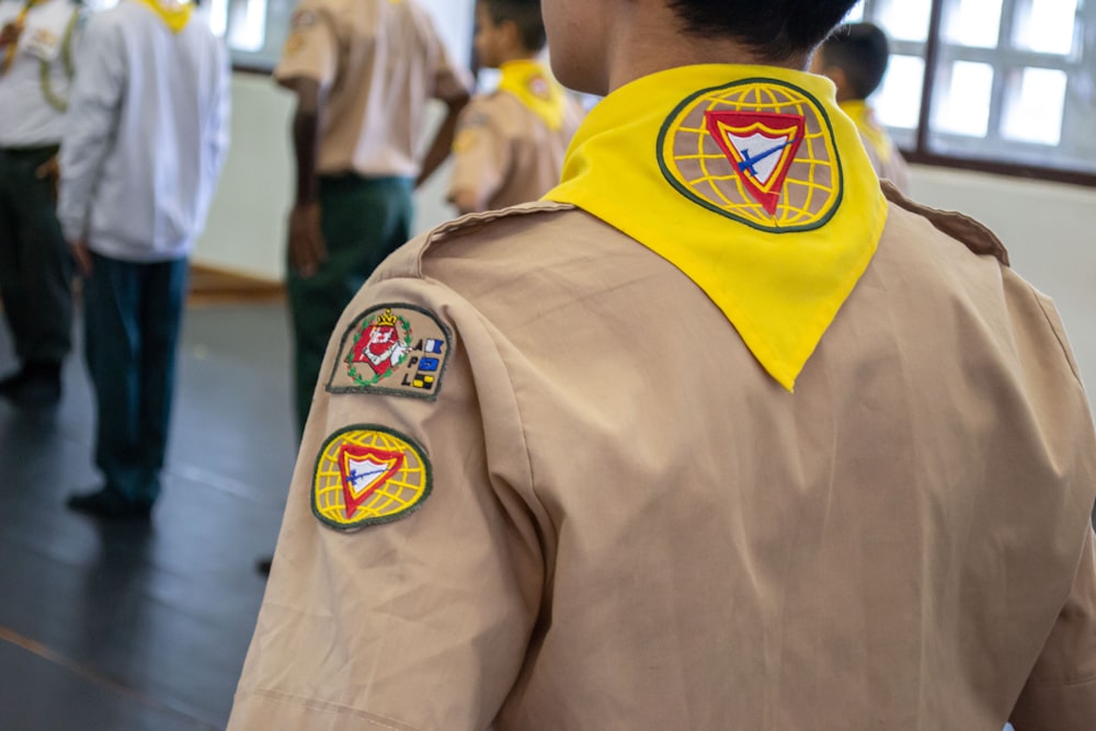 a person wearing a yellow jacket with a logo on it