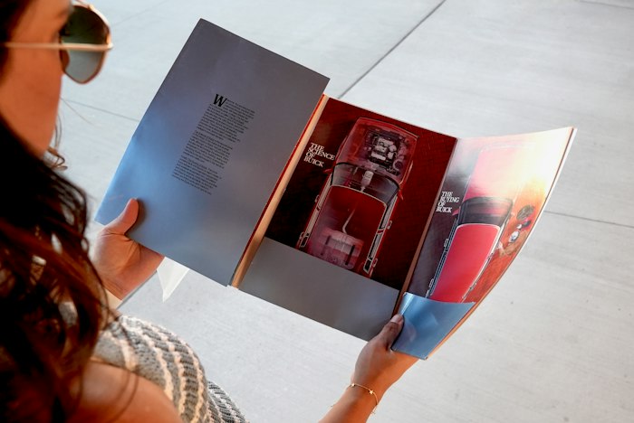 Woman opening a folded business brochure
