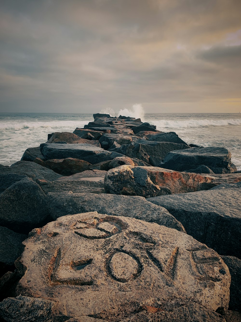 a rocky beach with waves crashing