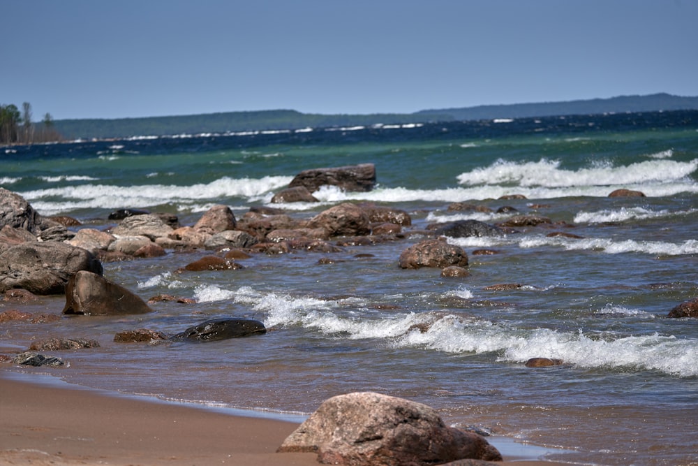 a rocky beach with waves crashing