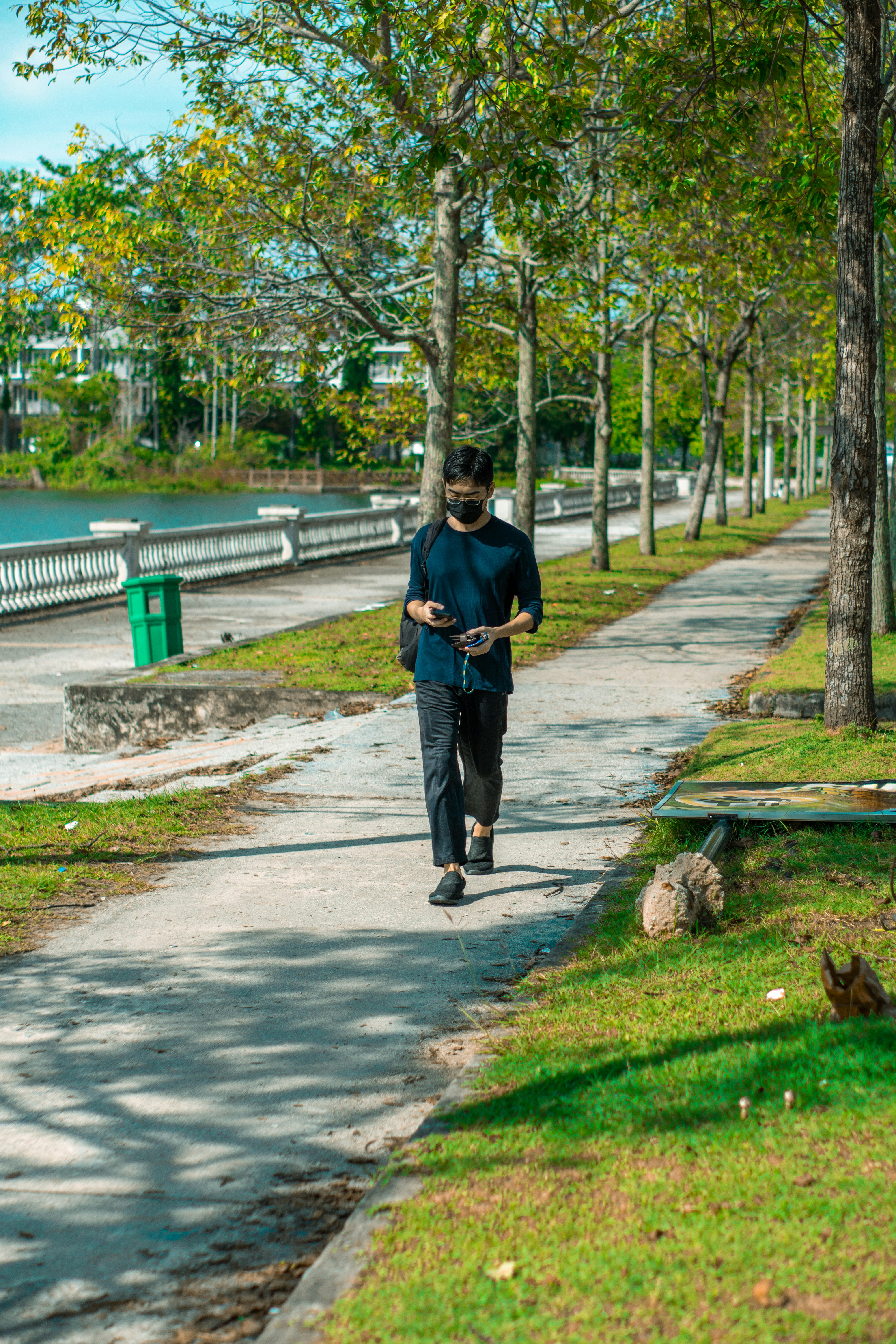 a man walking on a path in a park