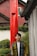 a person standing in front of a red pillar