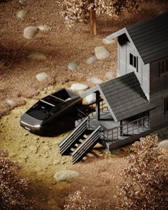 A modern pickup truck is parked next to a cabin with wooden exterior and a staircase leading to a porch. The area is surrounded by dry, brown grass and scattered rocks, with a tree nearby.