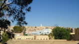A scenic view of the town with streets and houses under a clear sky.