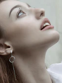 Close-up of a delicate silver nose piercing with a minimalist design.