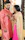 Photo of a joyful young Indian couple dressed in ethnic wear, standing close with warm smiles.